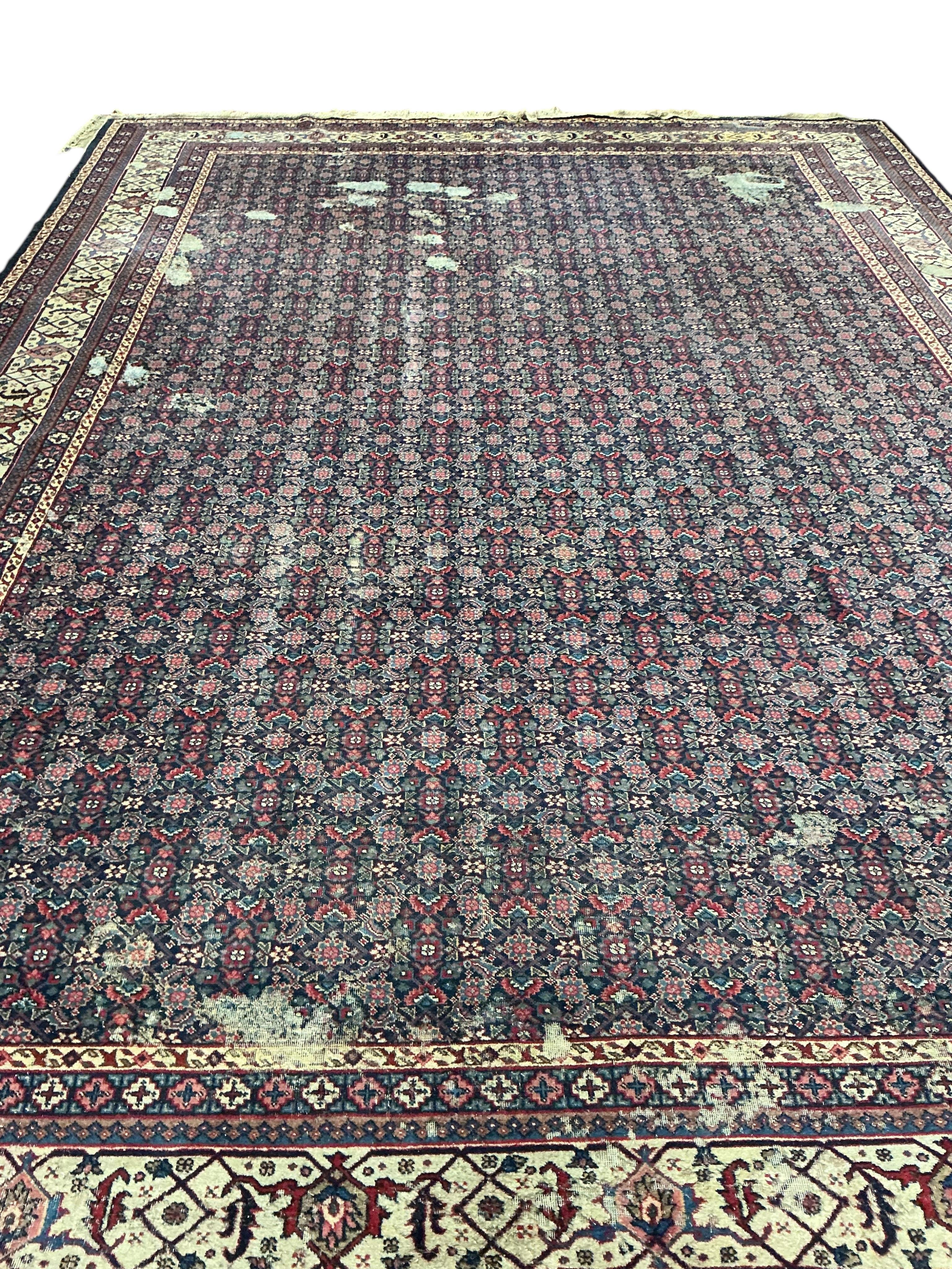 An early 20th century Tabriz blue ground floral carpet, moth damage, 440 x 340cm